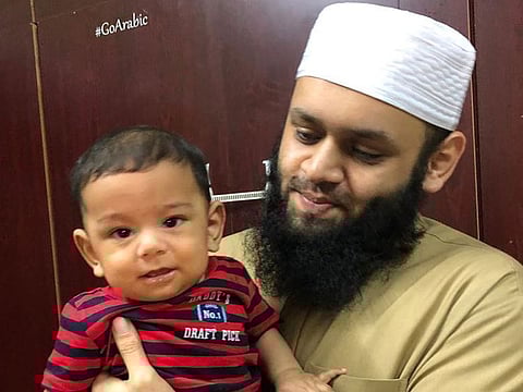 Qamaruddeen Bin Muhammed Najmuddeen with his seven-month-old son Ameenuddeen 