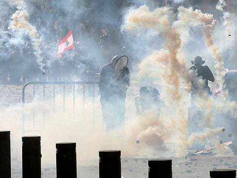 Riot police fire tear gas at demonstrators during a protest on August 8, 2020, following Tuesday's blast, in Beirut, Lebanon. 