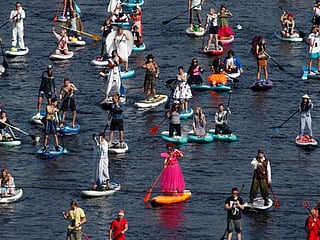 Photos: Paddleboard enthusiasts bring colours to St. Petersburg canals