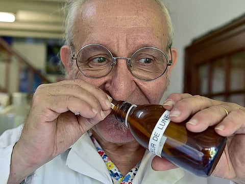 Geneticist and 'aroma sculpturer' Michael Moisseeff sniffs a bottle as he speaks of his experiments at his laboratory in his home at Montegut-Lauragais near Toulouse, southwestern France.