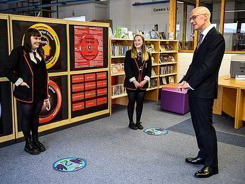 Deputy First Minister of Scotland and Cabinet Secretary for Education and Skills John Swinney visits Stonelaw High School on the day pupils receive their exam results, in Rutherglen, Glasgow, Scotland, Britain, August 4, 2020. Exams were cancelled in Scotland due to the coronavirus pandemic and pupils have been awarded grades based on assessment. 