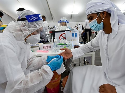 Paramedic staff at screening centre at the Ghantoot Rapid testing facility on Dubai-Abu Dhabi border. The procedure, known as Diffractive Phase Interferometry, or DPI, uses lasers to identify Covid-19 infections in less then 5 minutes