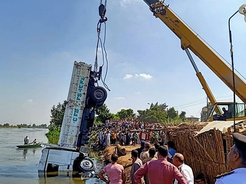 Rescue teams haul up a truck from a sunken Nile boat in Egypt.