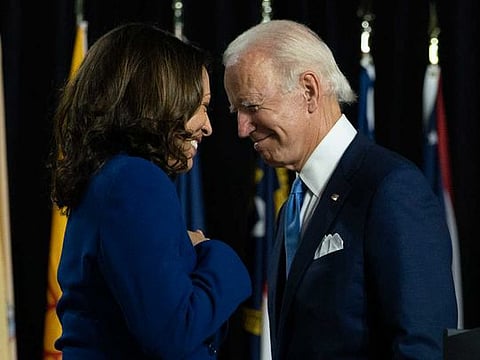 Democratic presidential candidate, former US vice-president Joe Biden and his running mate Senator Kamala Harris pass each other during a campaign event in Wilmington, Delaware, on August 12, 2020.