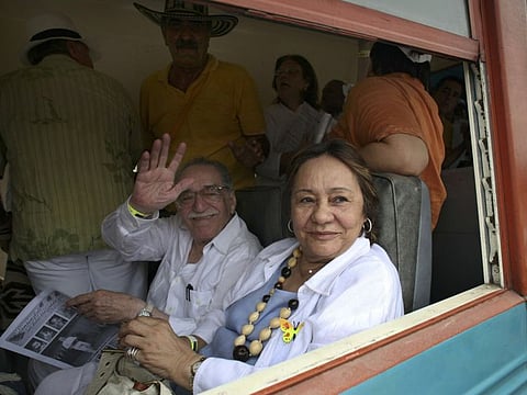 Gabriel Garcia Marquez waves upon his arrival on a train with his wife Mercedes Barcha, right, to Aracataca, on his first visit in 25 years to his hometown in northeastern Colombia on May 30, 2007.