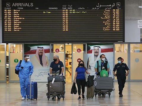 Travellers arrive at Kuwait international Airport, in Farwaniya, about 15km south of Kuwait City.