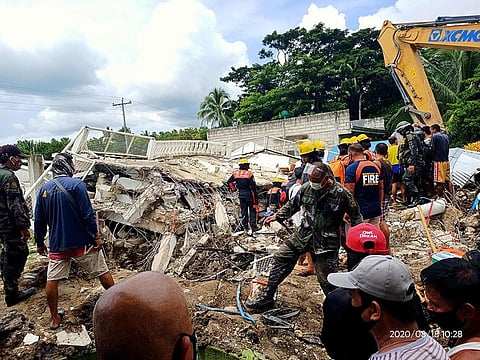 Rescuers looking for survivors at the site of a damaged house after a 6.6-magnitude earthquake hit the town of Cataingan in the central Philippine province of Masbate.