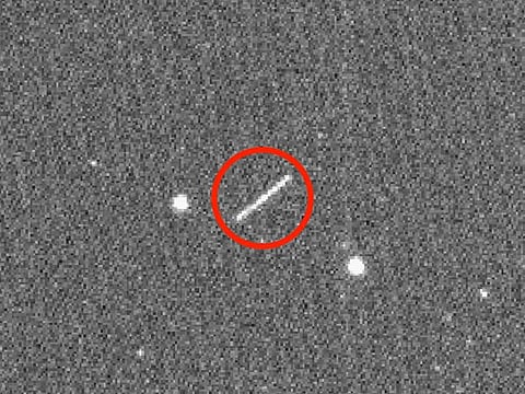 This NASA/JPL/ZTF/Caltech Optical Observatories handout image obtained on August 18, 2020 shows asteroid 2020 QG (the circled streak in the centre) which came closer to Earth than any other nonimpacting asteroid on record. Near Earth Asteroids, or NEAs, pass by our home planet all the time. But an SUV-size asteroid set the record this past weekend for coming closer to Earth than any other known NEA: It passed 2,950 kilometers above the southern Indian Ocean on August 16. 