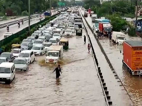 Huge traffic jam is seen due to waterlogging at the Delhi- Gurugram Highway following heavy rainfall in the region, in Gurugram on Wednesday. 