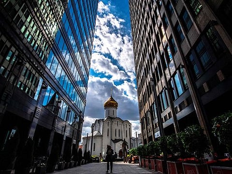 A woman wearing a face mask to protect against the coronavirus disease walks along a street in central Moscow on August 20, 2020