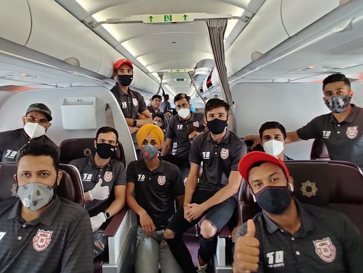 Kings XI Punjab players wear their masks on the flight to the UAE