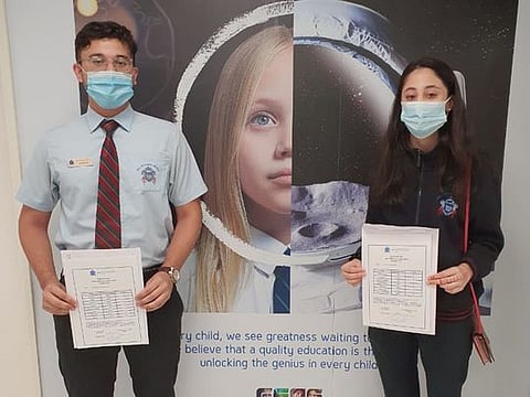 Maryam (head girl and last years winner of Sheikha Fatima award) and Saif (head boy) from GEMS Winchester School Dubai celebrate their GCSE results