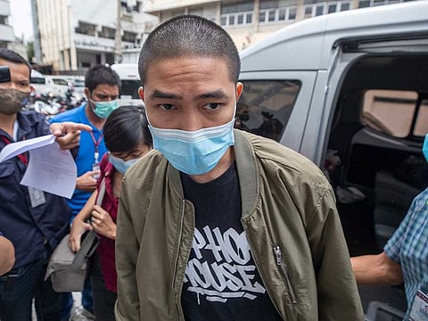 Key member of the music group Rap Against Dictatorship, Dechathorn Bamrungmuang arrives at the Samranrat police station in Bangkok, Thailand, Thursday, Aug, 20, 2020. Thai police arrested Dechathorn and four pro-democracy activists in a crackdown on growing protests that have emerged as the most serious threat to the government led by a former army general they accuse of incompetence and corruption. 