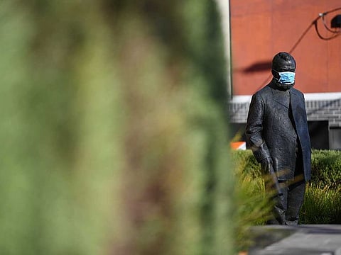 A face mask is seen on a statue as the city operates under lockdown in response to an outbreak of the coronavirus disease (COVID-19) in Melbourne, Australia, August 21, 2020. 