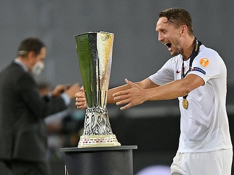 Luuk De Jong embraces the Europa League trophy