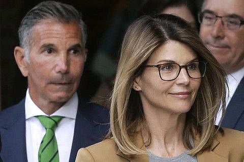 In this April 3, 2019 file photo, actress Lori Loughlin, front, and husband, clothing designer Mossimo Giannulli.