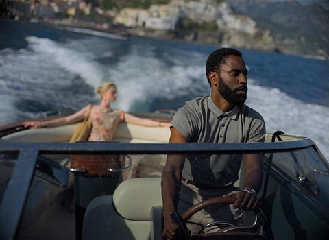 Elizabeth Debicki, left, and John David Washington in a scene from "Tenet." 