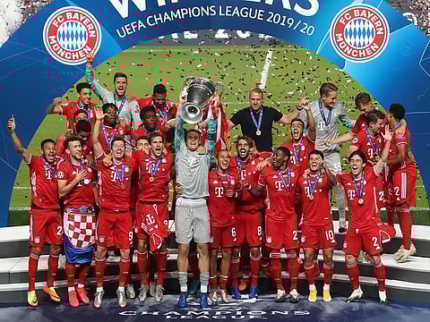 Bayern Munich players celebrate with the trophy after winning the Champions League.