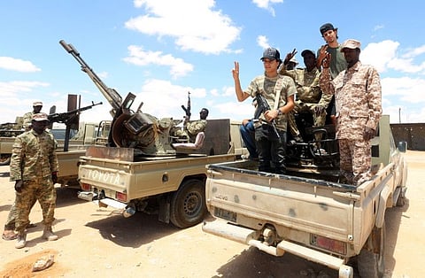 A file photo taken on July 20 shows fighters loyal to the Libyan Government of National Accord (GNA) secure the area of Abu Qurain, half-way between the capital Tripoli and Libya's second city Benghazi, against forces loyal to Khalifa Haftar, who is based in eastern Benghazi. 