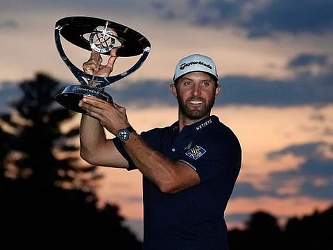 Dustin Johnson holds the trophy after winning the Northern Trust tournament at TPC Boston