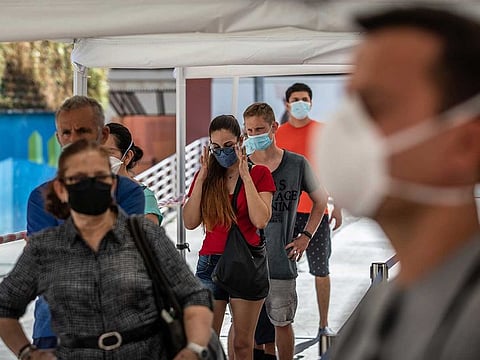 Residents wearing protective face masks queue outside a mass coronavirus screening facility in the Sant Ildefons district of Barcelona, Spain, on Tuesday, Aug. 25, 2020. Spanish Prime Minister Pedro Sanchez rejected calls for a new national lockdown as the nation reemerges as the epicenter of the coronavirus pandemic in Europe. 