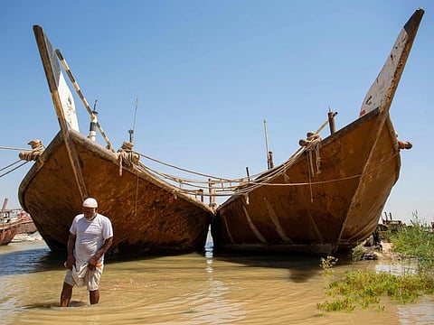 An Iraqi farmer inspects the water level near his land in Iraq's southern port city of Al Faw, 90km south of Basra near the Shatt Al Arab and the Gulf on August 17, 2020. 