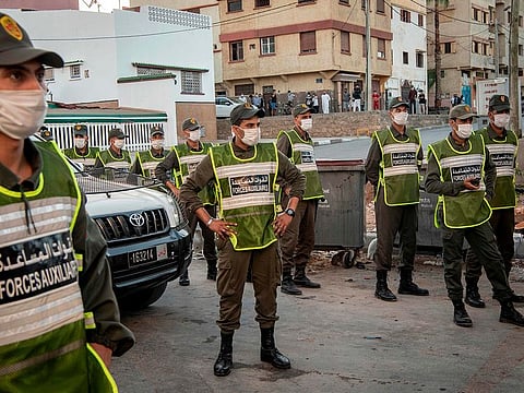 Members of Morocco's Interior Ministry Auxiliary Forces patrol a neighbourhood to enforce the reimposed lockdown due to a spike in coronavirus (COVID-19) cases, in the capital Rabat's district of Takadoum on August 17, 2020.