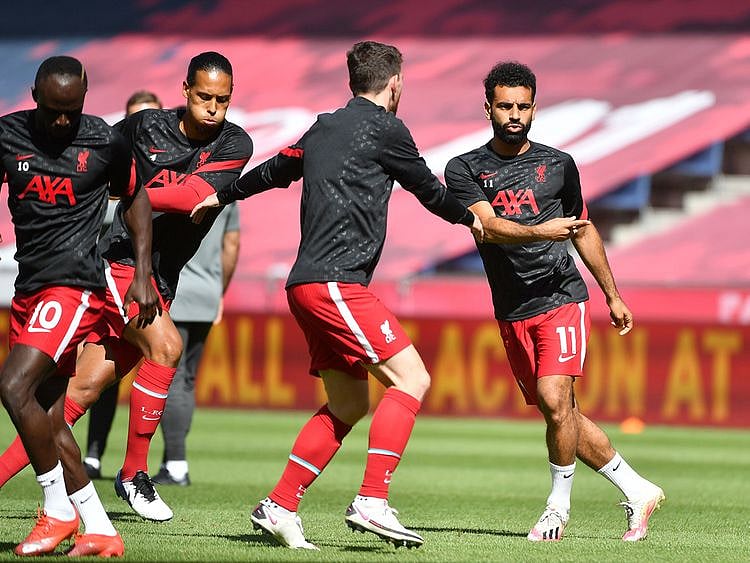 Liverpool's Mo Salah, Andrew Robertson, Virgil van Dijk and Sadio Mane warm up before the RB Salzburg match.