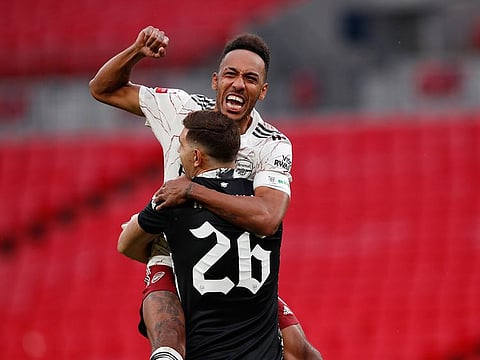 Arsenal's Pierre-Emerick Aubameyang celebrates with Arsenal goalkeeper Emiliano Martinez