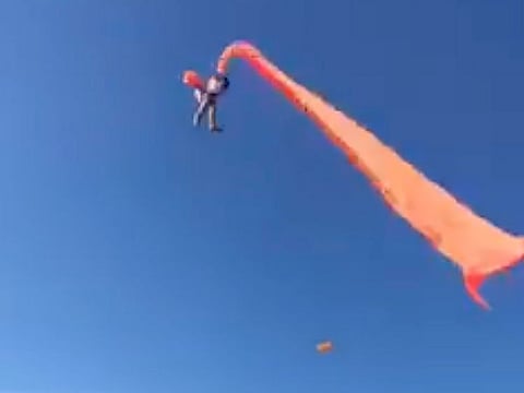 In this image made from video, a 3 year old girl is lifted into the air by a large kite during a kite festival in Hsinchu, northern Taiwan.