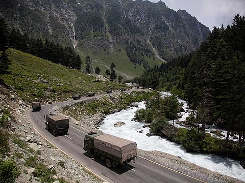 In this June 17, 2020, file photo, an Indian army convoy moves on the Srinagar- Ladakh highway at Gagangeer, north-east of Srinagar, India. 