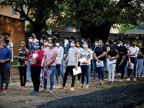 Students wearing protective face masks wait to enter an examination centre for Joint Entrance Examination (JEE), amidst the spread of the coronavirus disease (COVID-19), in Ahmedabad, India