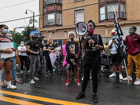 A crowd of protesters gather, Wednesday, Sept. 2, 2020, in Rochester, N.Y., near the site where Daniel Prude was restrained by police officers. Prude, a Black man who had run naked through the streets of the western New York city, died of asphyxiation after a group of police officers put a hood over his head, then pressed his face into the pavement for two minutes, according to video and records released Wednesday by his family. Prude died March 30 after he was taken off life support, seven days after the encounter with police in Rochester. 