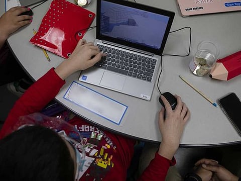 A student wearing a protective mask and face shield attends an online class from a learning center in Miami, Florida, U.S., on Friday, Sept. 4, 2020. In a victory for state education leaders, an appeals court said Monday that Florida’s school reopening order did not force students back to campus, nor teachers back into classrooms, and should remain in effect while the lawsuits challenging its constitutionality move through the court system. 