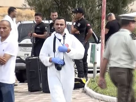 In this frame grab from a video, Tunisian police officers investigate after Tunisian forces shot dead three suspected militants who rammed their vehicle into security officers and attacked them with knives, killing one and injuring another in the coastal resort town of Sousse, eastern Tunisia, on September 6.  