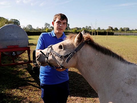French farrier Remy Marechal stands with his injured horse named Noel at his farm in Preux-au-Bois, France, September 7, 2020. 