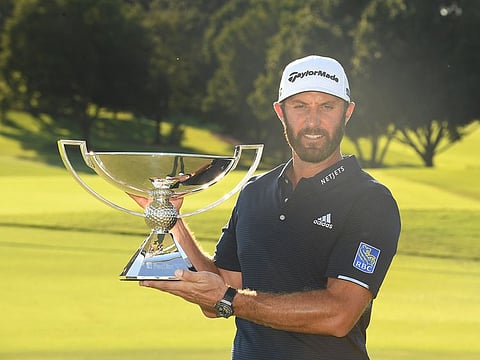 Dustin Johnson with the FedEx Cup trophy after the final round of the Tour Championship golf tournament at East Lake Golf Club.