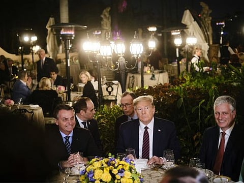 President Donald Trump, second from right, hosts President Jair Bolsonaro of Brazil, left,  at a dinner at Mar-a-Lago in Palm Beach on March 7, 2020. At right is National Security Adviser Robert O'Brien.