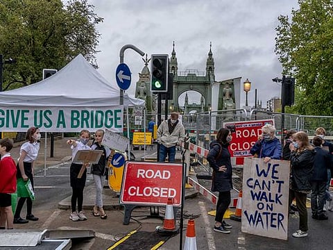 A protest against the closing of Hammersmith Bridge in London on Sept. 3, 2020. Three major crossings on the Thames are closed to cars — one of them considered too dangerous even to walk across and even the landmark Tower Bridge was recently shut for two days. 