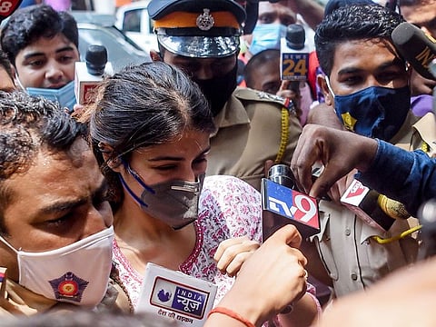 Rhea Chakraborty (C) arrives at the Narcotics Control Bureau (NCB) office for enquiry regarding Sushant Singh Rajput case, in Mumbai on September 6, 2020. 