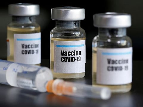 Small bottles labeled with a "Vaccine COVID-19" sticker and a medical syringe are seen in this illustration taken April 10, 2020.