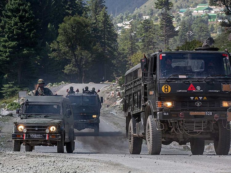 Indian army convoy moves on the Srinagar- Ladakh highway at Gagangeer border