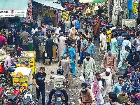 People visit a mobile phone market in Lahore. Pakistan’s low number of cases has baffled public health experts.