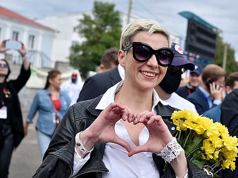 Maria Kolesnikova, Viktor Babaryko's campaign chief, makes a heart sign with her hands during a campaign rally of presidential candidate Svetlana Tikhanovskaya in the town of Maladzyechna, some 70 km northwest of Minsk, on July 31, 2020. Belarus investigators said on September 9, 2020 prominent opposition figures Maria Kolesnikova and Maxim Znak had been detained in a national security probe as Minsk ramped up a crackdown on a protest movement. 
