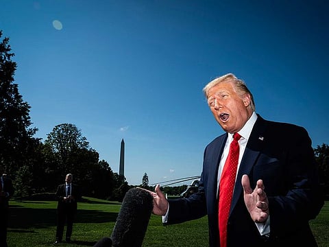 President Donald Trump stops to talk to reporters as he walks to board Marine One and depart from the South Lawn at the White House on Aug 17. 