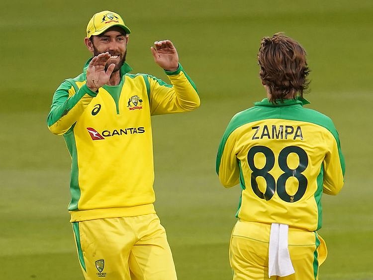 Glenn Maxwell celebrates with Australia's Adam Zampa after taking a catch to dismiss England's Eoin Morgan