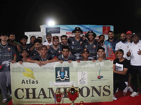 Kings Cricket Academy team poses with the winners' trophy at the Pacific Four Nations tournament in Ajman earlier this month.