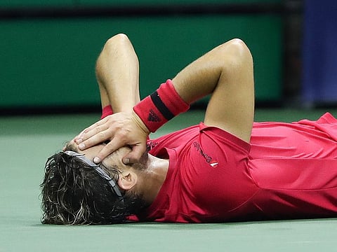 Dominic Thiem of Austria lays down in celebration after winning championship point after a tie-break during his Men's Singles final match against and Alexander Zverev of Germany.