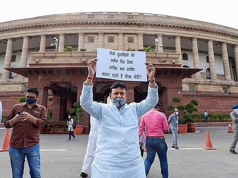 A Congress MP demonstrates near Mahatma Gandhi statue demanding discussion over India-China border issue in Ladakh, during the ongoing Monsoon Session of Parliament, at Parliament House in New Delhi, Tuesday, Sept. 15, 2020. 