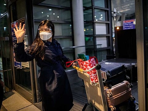 Filipino nurse April Glory waves to her family before leaving for the UK, outside Ninoy Aquino International Airport in Pasay City, Metro Manila, Philippines